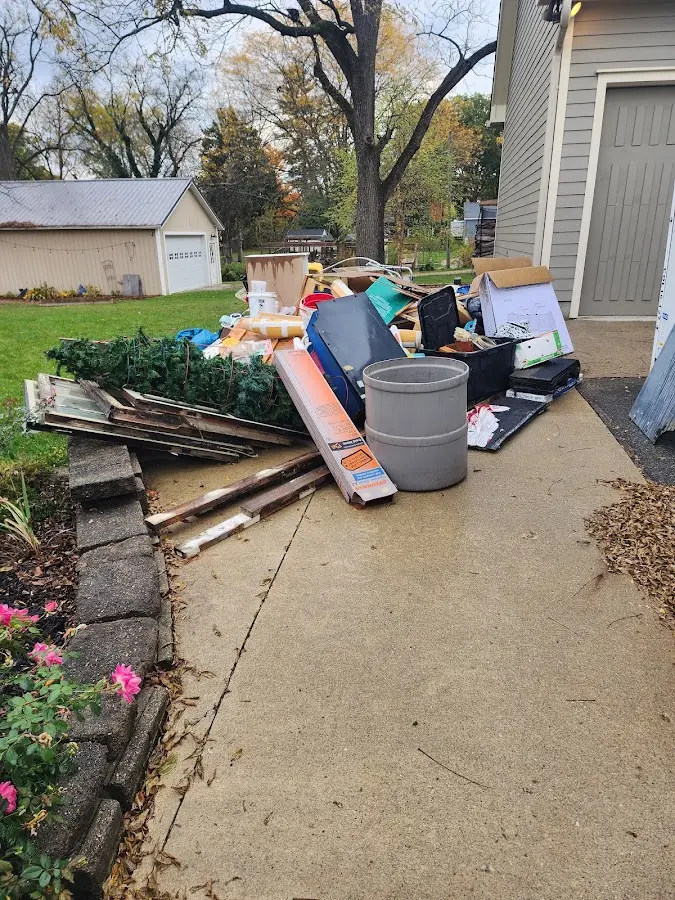 Dumpster being loaded with debris for Estate Cleanout Dumpster Rental in Glen Ridge